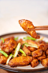 Delicious homemade stewed fish slices with scallion in wooden background, Taiwan delicacies, top view, copy space