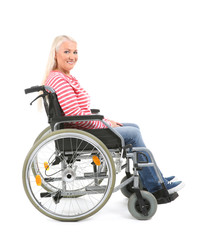 Obraz na płótnie Canvas Mature woman sitting in wheelchair on white background