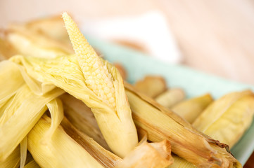 Delicious homemade izakaya-like roast baby corn in wooden background, Taiwan delicacies, top view, copy space
