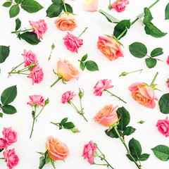 Floral pattern made of roses flowers, petals and leaves on white background. Flat lay, top view.