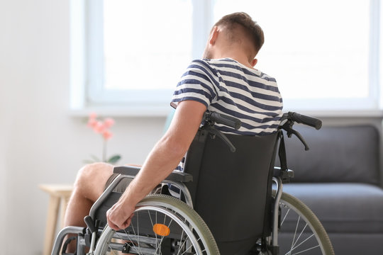 Depressed Young Man In Wheelchair At Home