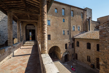 Fototapeta na wymiar San Gimignano Italy July 2nd 2015 : Entrance and courtyard to the Musei Civici in San Gimignano, Tuscany, Italy