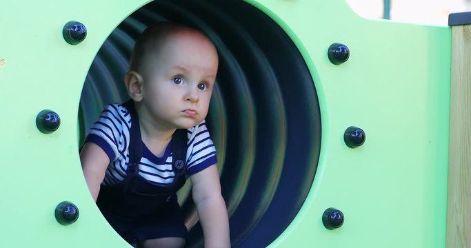 Cute Baby Boy In A Playground Tunnel. Close Up View - DCi 4K Resolution