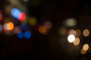 Abstract city night defocused light, blur bokeh, colorful & dark background. Dreamy, shiny, urban & backdrop.