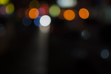 Abstract city night defocused light, blur bokeh, colorful & dark background. Street, backdrop, dreamy & artistic.