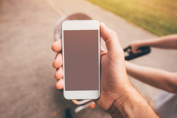 Phone is more interesting than baby in the stroller