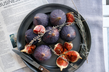 Plate with fresh ripe purple figs on table, top view