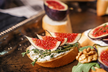 Tasty sandwiches with ripe fig on metal tray, closeup