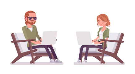 Young red-haired man and woman sitting working with laptop
