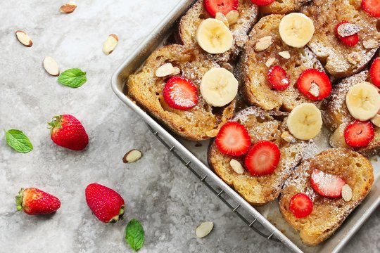 Overnight Baked French Toast Topped With Berries Bananaa And Nuts, Overhead View