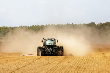 Fototapeta premium tractor handles land, very put