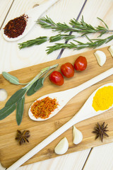 Cooking Hot Spicy Food Concept. Dry spices and herbs in wooden spoon on a cutting board