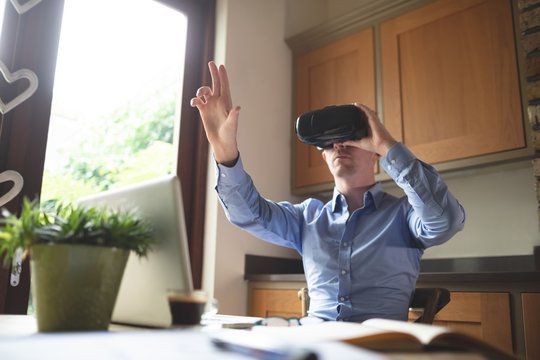 Man using virtual reality headset in kitchen