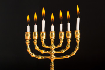 Bronze Hanukkah menorah with burning candles