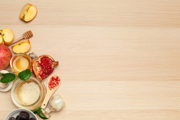 Honey, pomegranate, apple and dates on wooden board. Jewish New Year Rosh hashana celebration