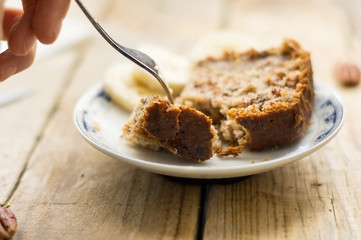 Eating homemade banana breadth a silver fork