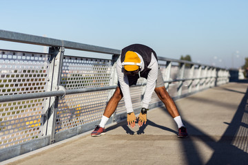 Young active man doing stretching on the bridge before training - Powered by Adobe