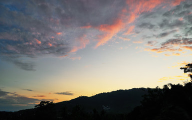 Spectacular sunset over mountains and trees on a tropical island
