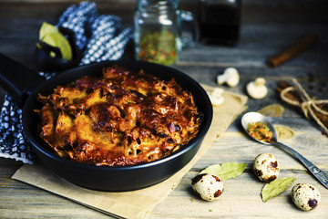 baked meat pie with macaroni and cheese filling on a plate