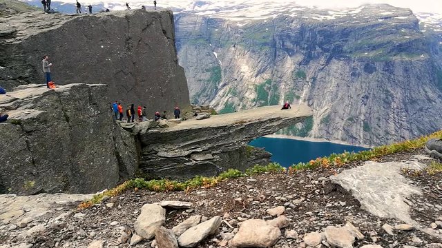 queue of tourists for making photo on Trolltunga