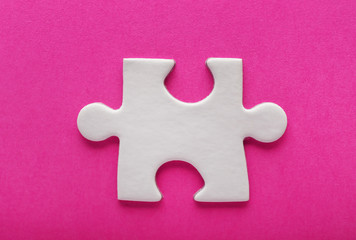 Piece of jigsaw puzzle on color background