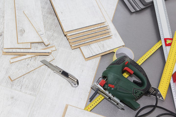 Planks of laminate floor and tools to install them.