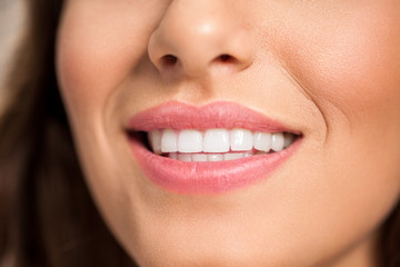 Smiling female lips with white teeth