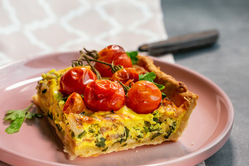 A piece of pie with bacon, cheese and tomatoes.