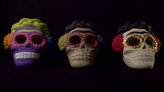 Three mexican skuls over a black background for halloween