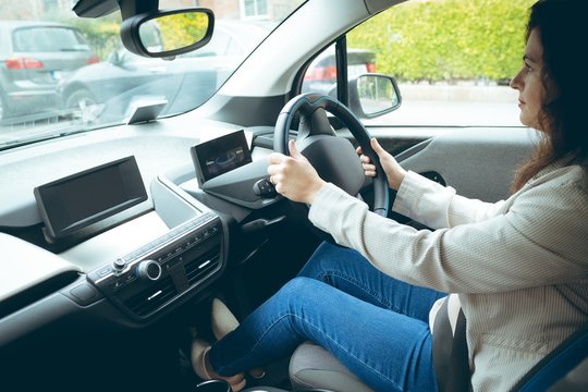Businesswoman driving car in city