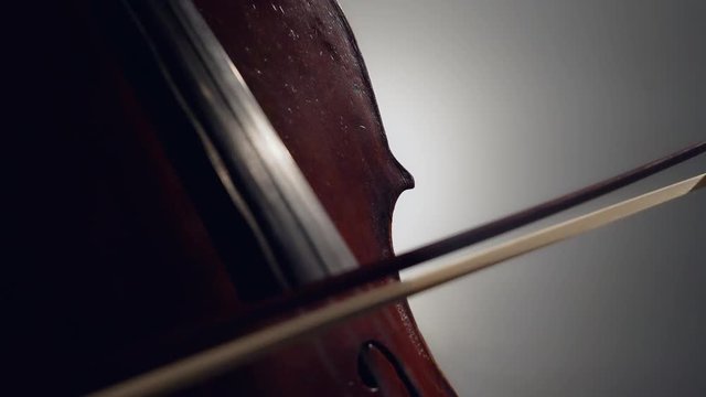 The cellist performs on stage.