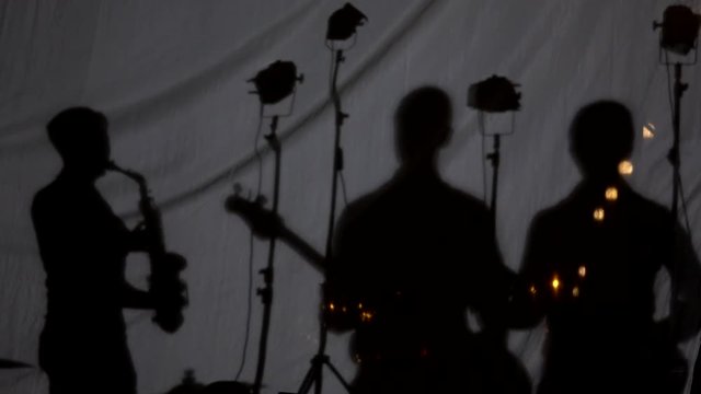 Silhouette music band dancing and playing their instruments. Musical instruments.