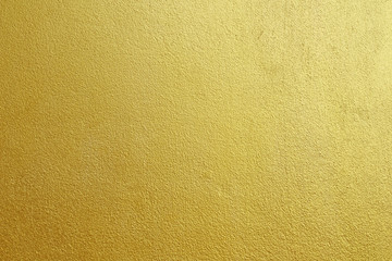 Gold concrete wall on background texture.