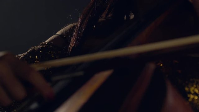 The cellist performs on stage.