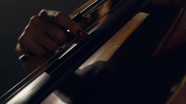 The cellist performs on stage.