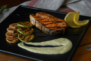 Baked salmon fish fillet with tomatoes, mushrooms and spices. Diet menu. Top view. Flat lay