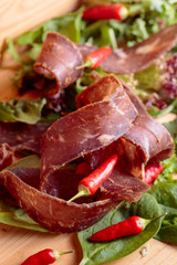 Dry beef jerky with herbs and red peppers.
