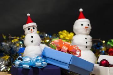 Christmas. Two toy Santa Claus. Gift boxes with Christmas-tree decorations. Garlands.