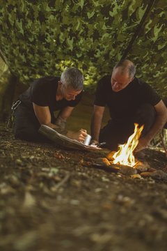 Two men looking at map in boot camp
