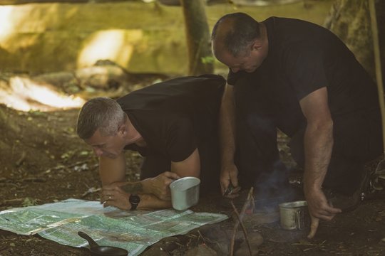 Two men looking at map in boot camp