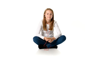 Young teen girl on white background listening to music