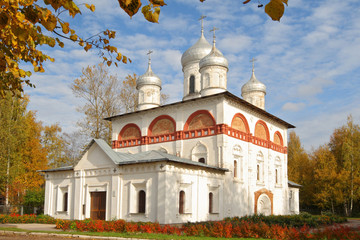 White church in Staraya Russa in autumn, blue sky with clouds