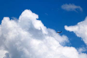Airplane in the sky with clouds and blue sky