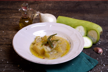 Zucchini dish in broth with potato and onion and herbs  