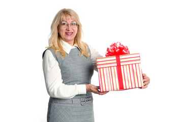 Senior woman with big gift box in hand on a light background.