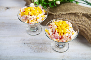 Delicious salad of crab sticks, cheese, tomato and corn.