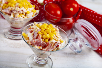 Delicious salad of crab sticks, cheese, tomato and corn.