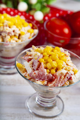 Delicious salad of crab sticks, cheese, tomato and corn.