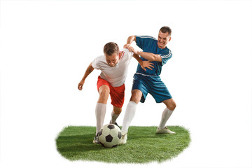 Fototapeta na wymiar Football players tackling for the ball over white background. Professional football soccer players in motion isolated white studio background. Fit jumping men in action, jump, movement at game.