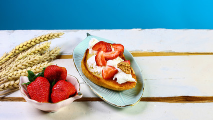 Healthy food, bruschetta with strawberry, nuts and cheese. Seasonal harvest crop local produce concept. Authentic lifestyle image. flat lay, Copy space